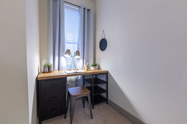 Home office nook with built-in desk and shelves at The Gramercy Apartments