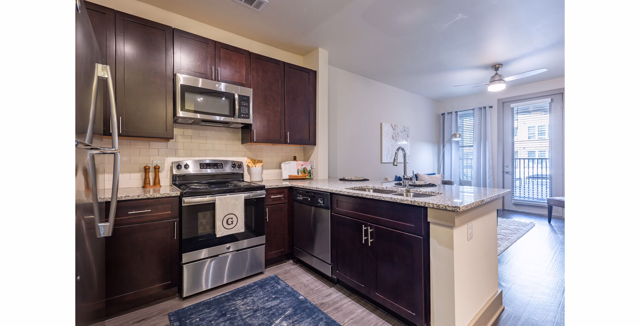Sleek kitchen with stainless steel appliances in The Gramercy Apartments