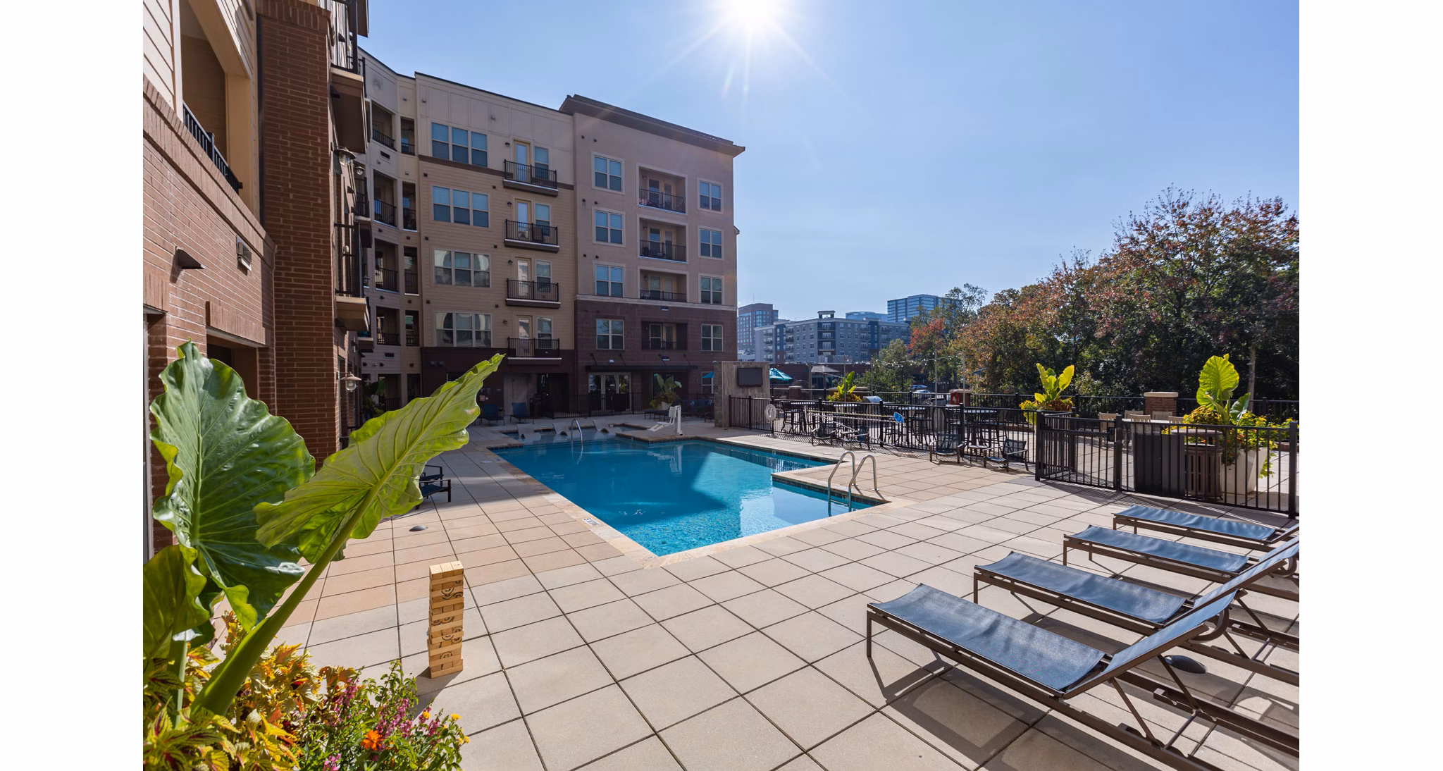 Luxury pool with city skyline views at The Gramercy Apartments