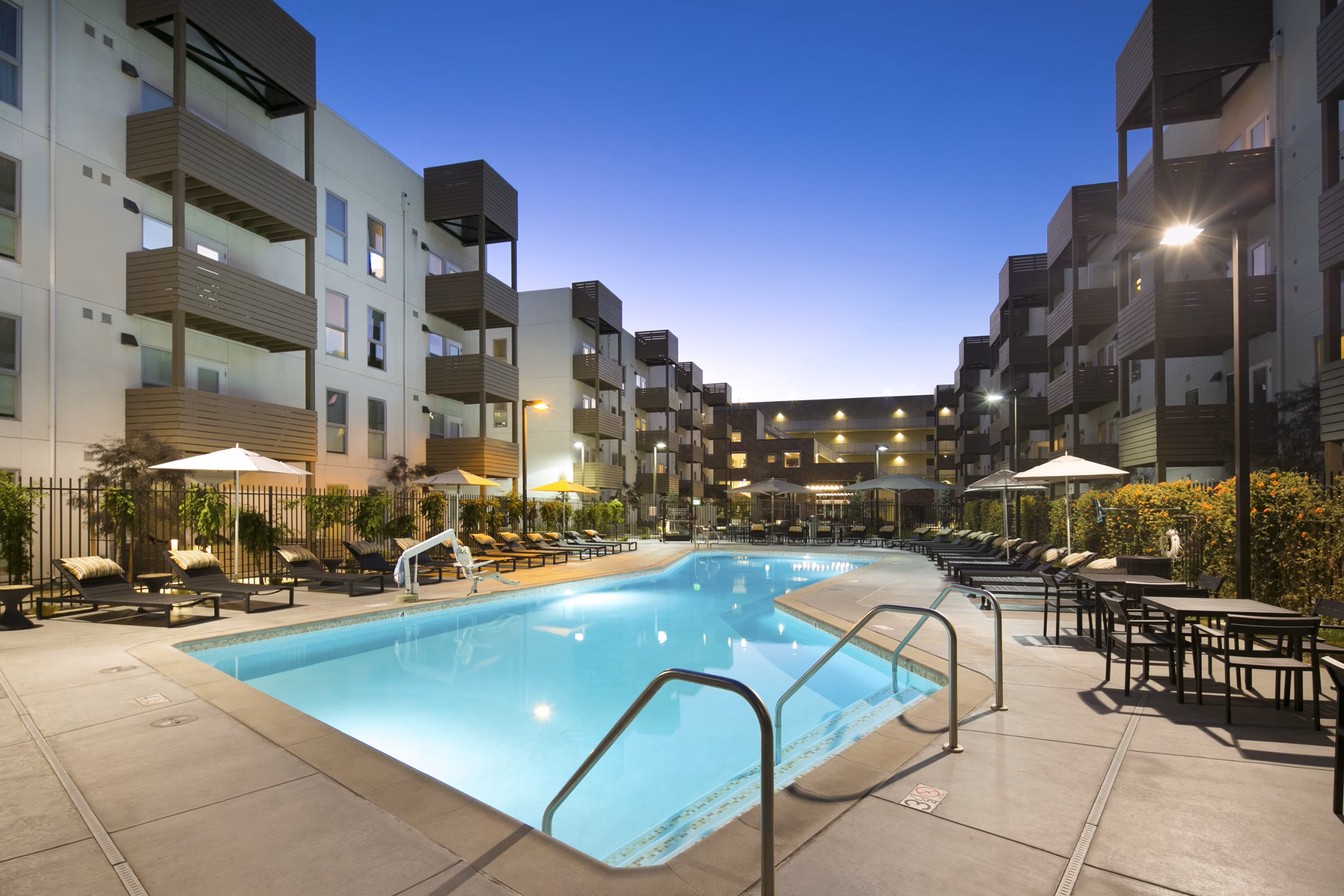 Resort-style pool with lounge chairs at Foundry Commons Apartments