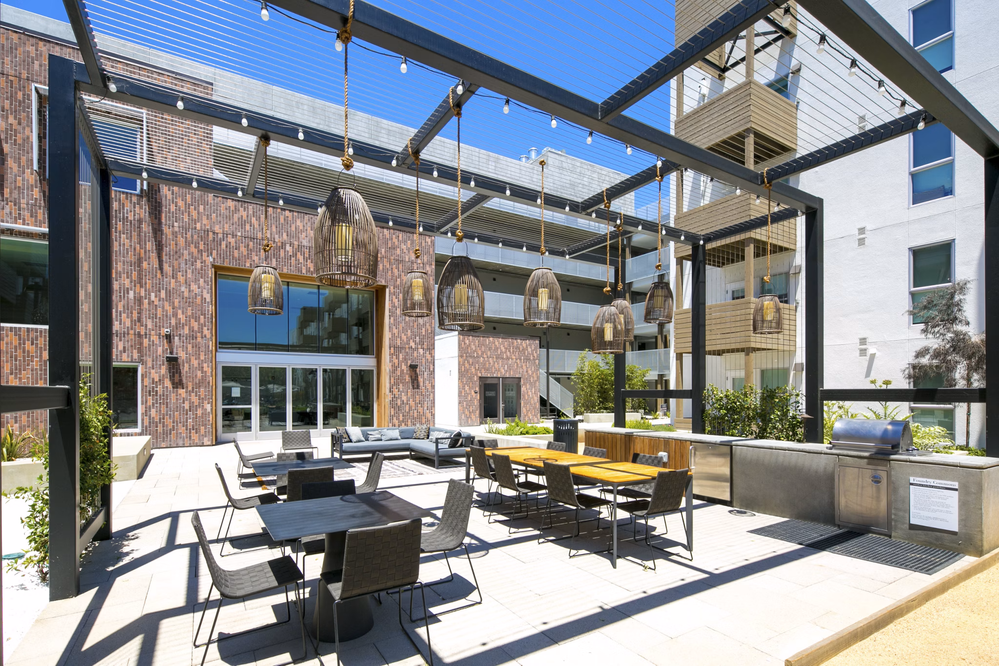 Outdoor grill area with modern seating at Foundry Commons Apartments
