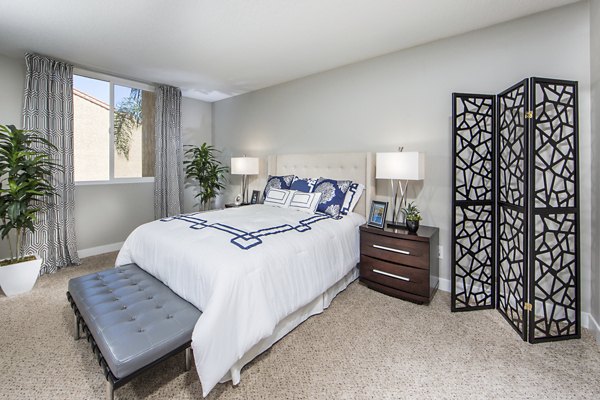 Cozy bedroom with ocean view at Avana Rancho Palos Verdes Apartments, featuring contemporary design and ample natural light