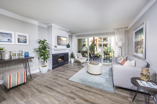 Living room with cozy seating and natural light at Avana Rancho Palos Verdes Apartments