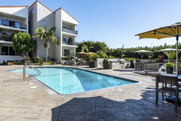 Outdoor pool with lounge chairs at Avana Rancho Palos Verdes Apartments