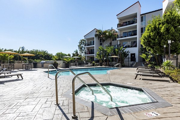 Outdoor pool with palm trees at Avana Rancho Palos Verdes Apartments