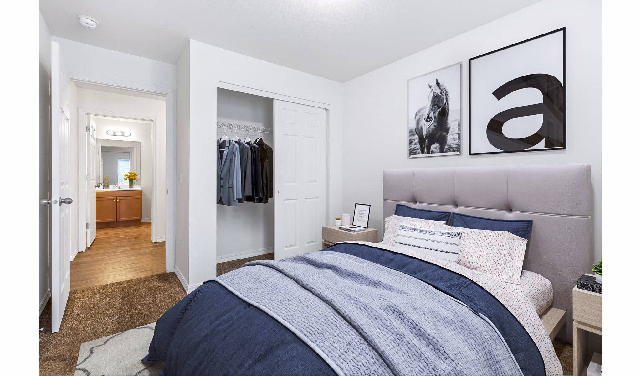 Chic bedroom with plush bedding and stylish decor at Carrington Place Apartments