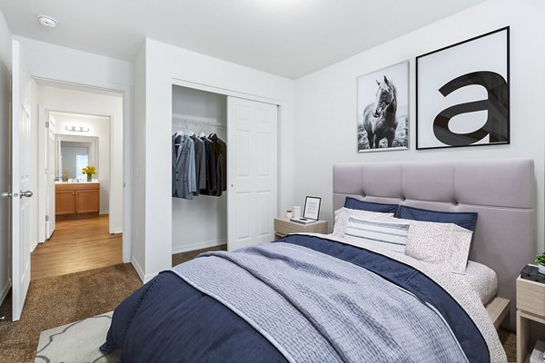 Chic bedroom with plush bedding and stylish decor at Carrington Place Apartments