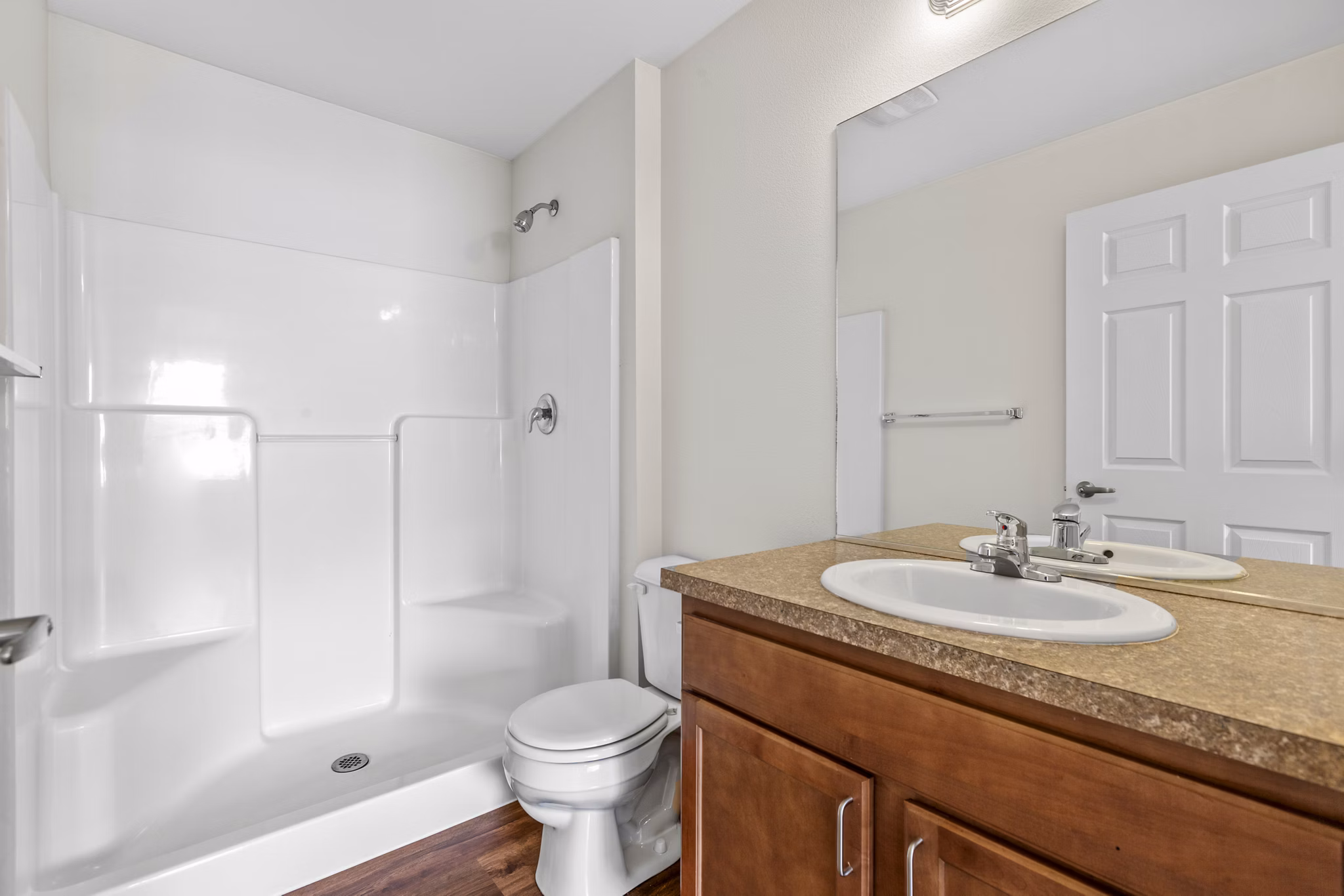 Modern bathroom with sleek fixtures at Carrington Place Apartments, featuring a spacious vanity and elegant tile flooring