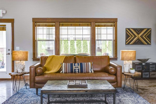 Carrington Place Apartments: Chic clubhouse with modern decor and cozy seating areas for residents to relax and socialize