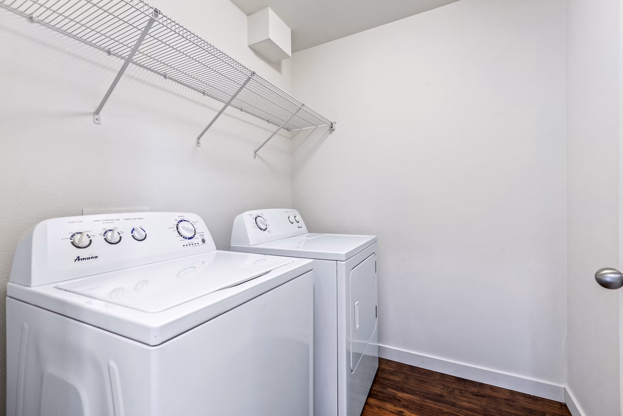 Laundry room featuring modern appliances in Carrington Place Apartments