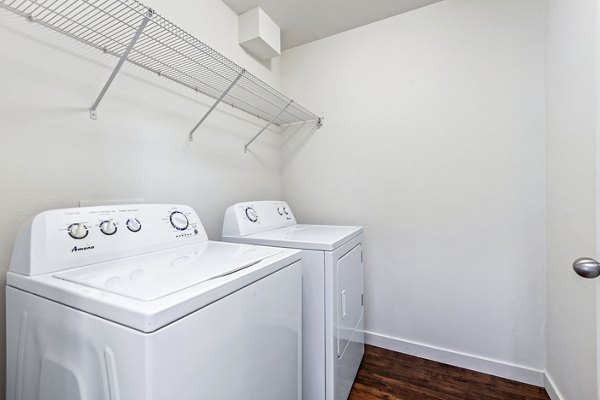 Laundry room featuring modern appliances in Carrington Place Apartments