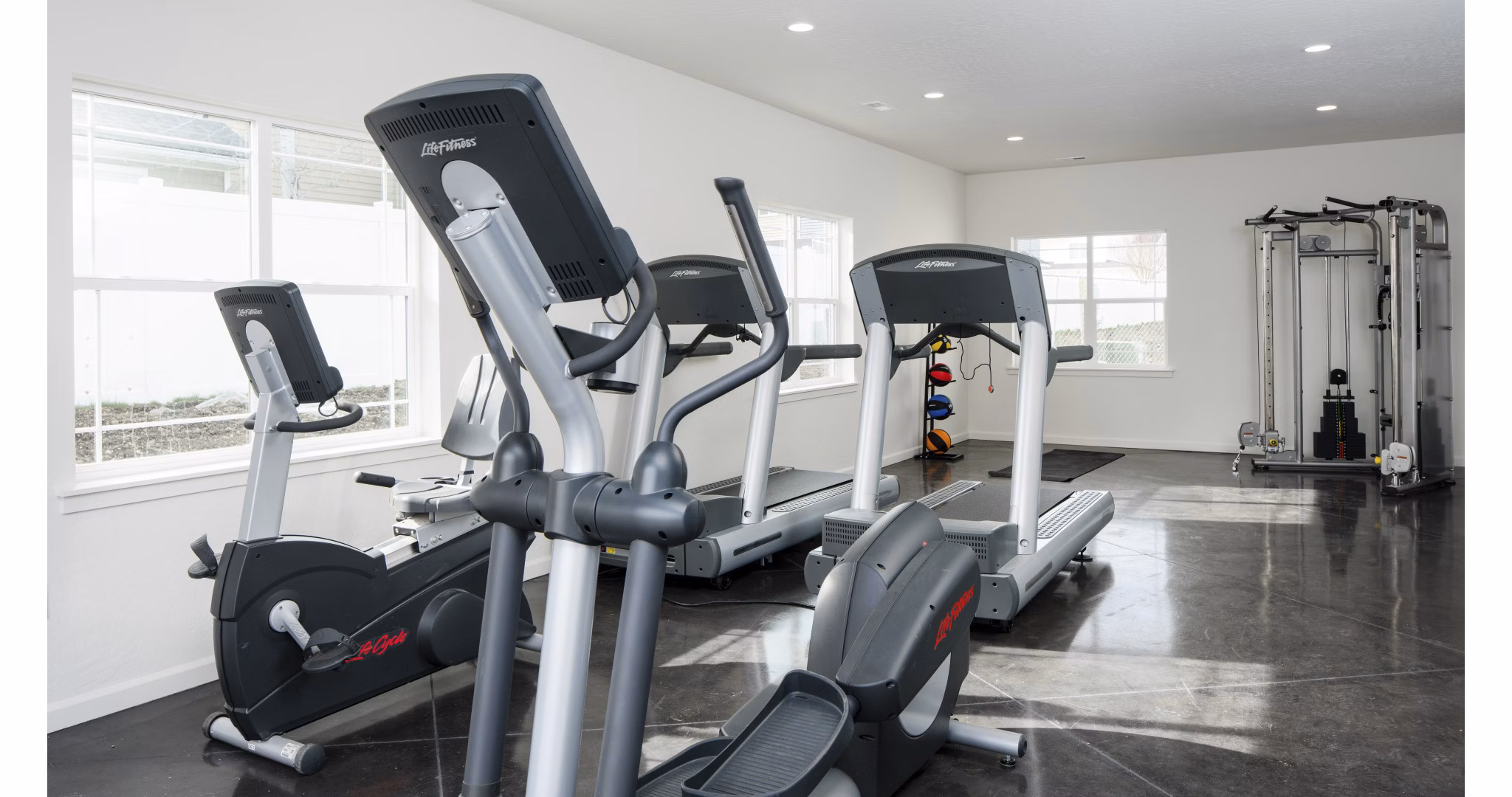 Modern fitness center with gym equipment at Villas at Tullamore Apartments
