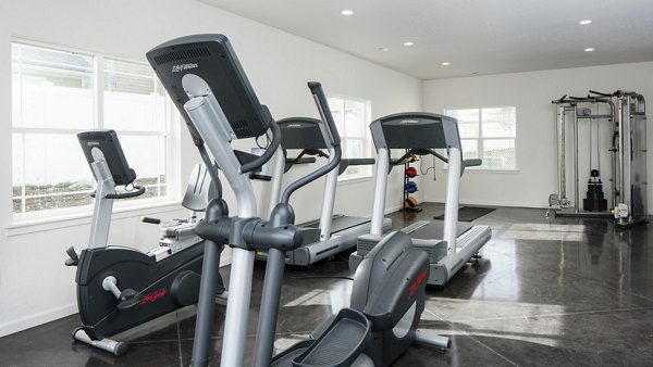Modern fitness center with gym equipment at Villas at Tullamore Apartments