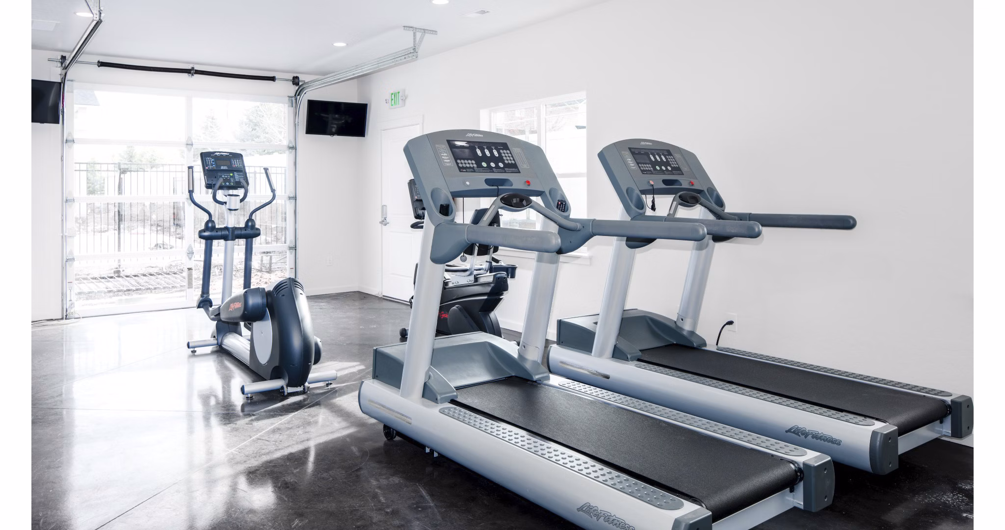 Modern fitness center featuring cardio machines at Villas at Tullamore Apartments
