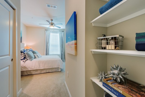 Cozy bedroom with large windows at Bridgeside at Patriots Point Apartments offering luxury living