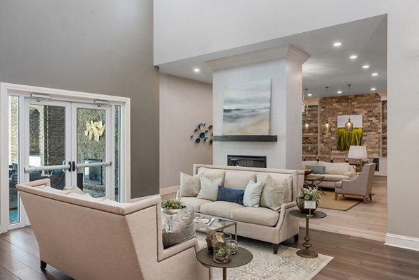 Clubhouse featuring modern lounge seating at Bridgeside at Patriots Point Apartments with views of the surrounding landscape