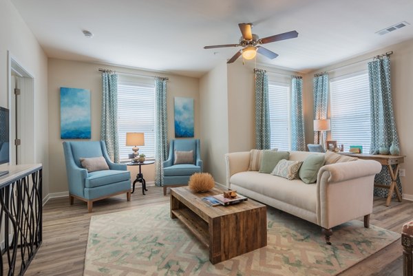 Spacious living room with modern decor and marina views in Bridgeside at Patriots Point Apartments