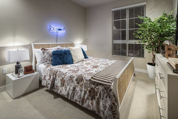 Bedroom with modern decor and large windows at Luxe Pasadena Apartments, offering luxury living in the heart of Pasadena