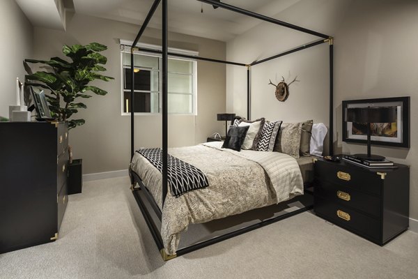 Modern bedroom with large windows and sleek design at Luxe Pasadena Apartments