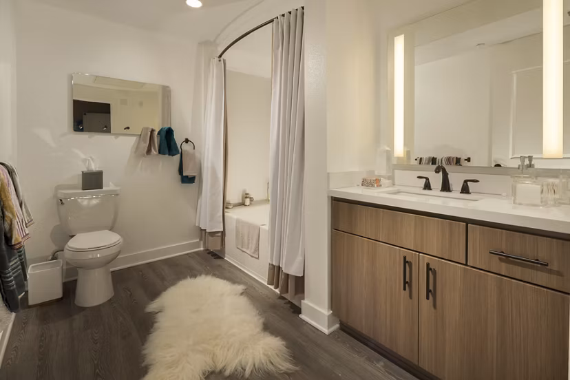 Bathroom featuring sleek marble countertops and modern fixtures at Luxe Pasadena Apartments