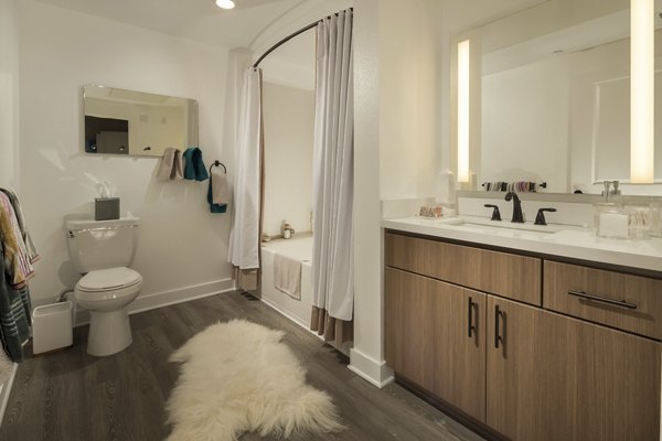 Bathroom featuring sleek marble countertops and modern fixtures at Luxe Pasadena Apartments