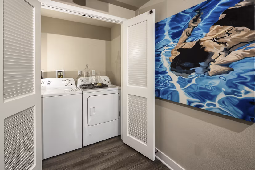 Laundry room with modern appliances at Luxe Pasadena Apartments