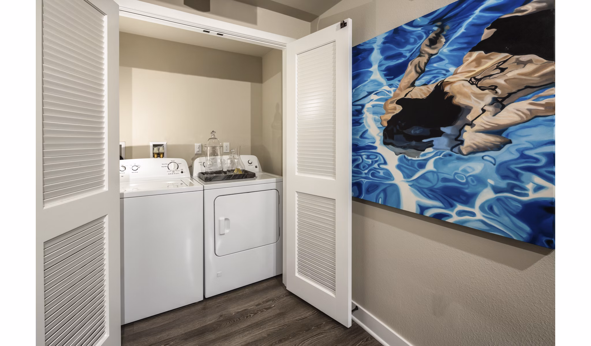 Laundry room with modern appliances at Luxe Pasadena Apartments