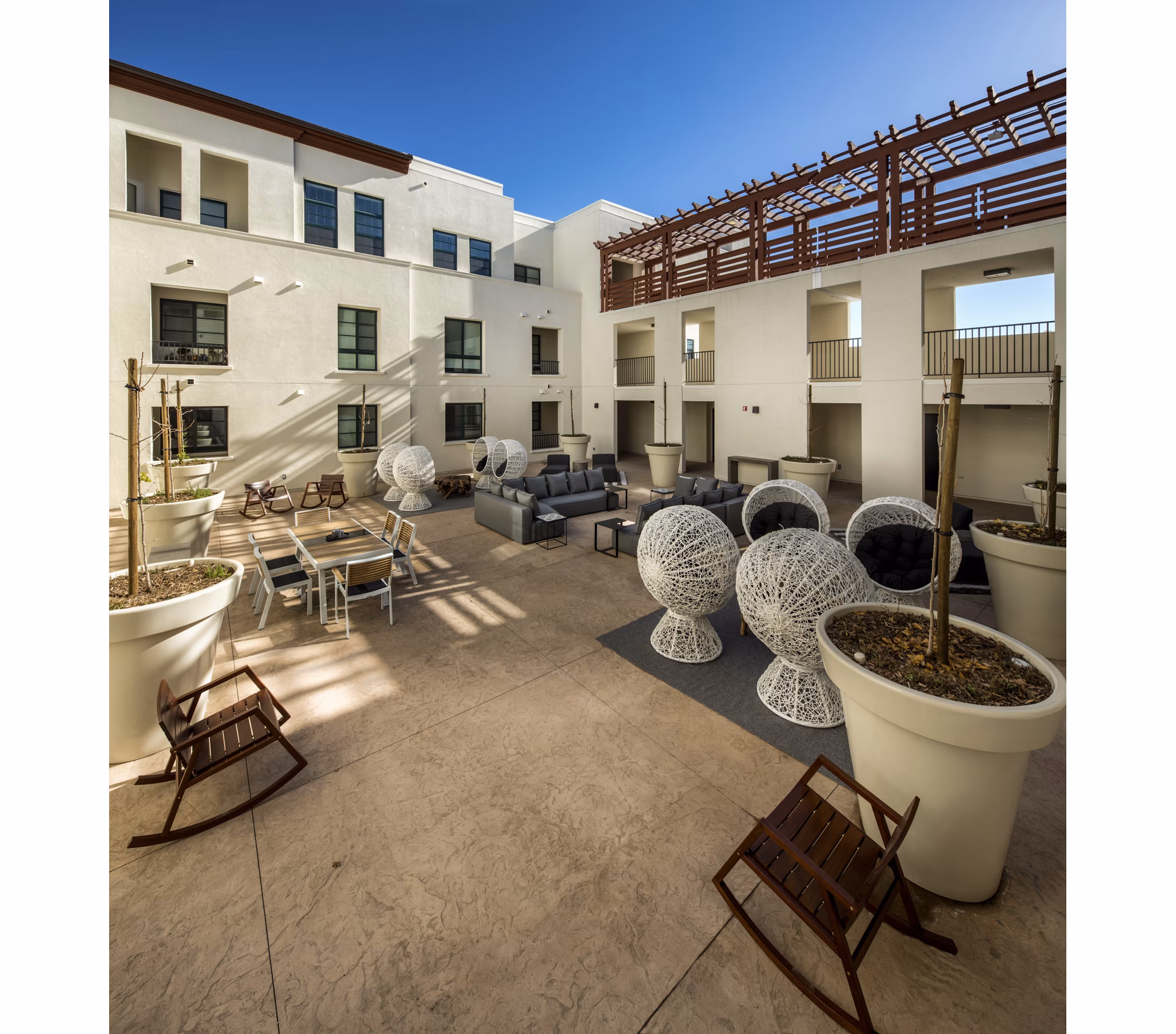 Courtyard with lush greenery and comfortable seating at Luxe Pasadena Apartments