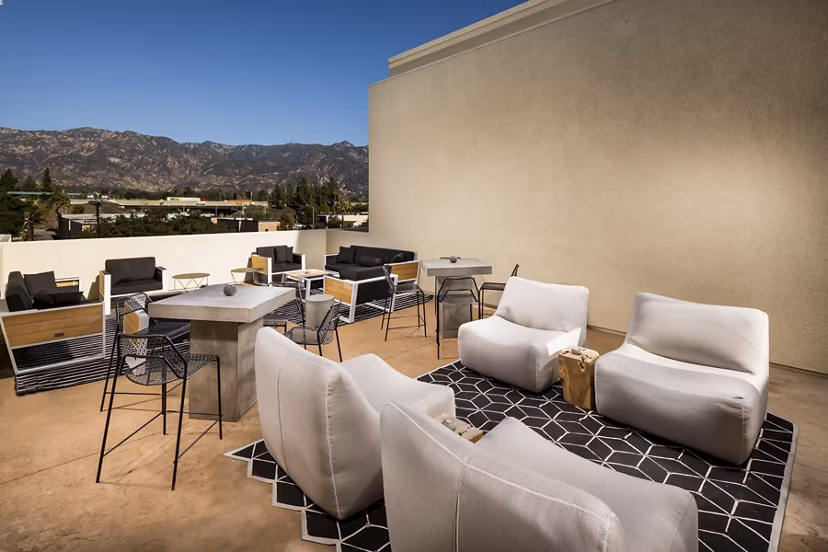 Stylish rooftop deck with seating and skyline views at Luxe Pasadena Apartments, luxury living in the heart of Pasadena