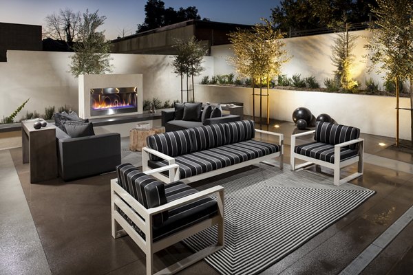 Courtyard with lush gardens and seating areas at Luxe Pasadena Apartments