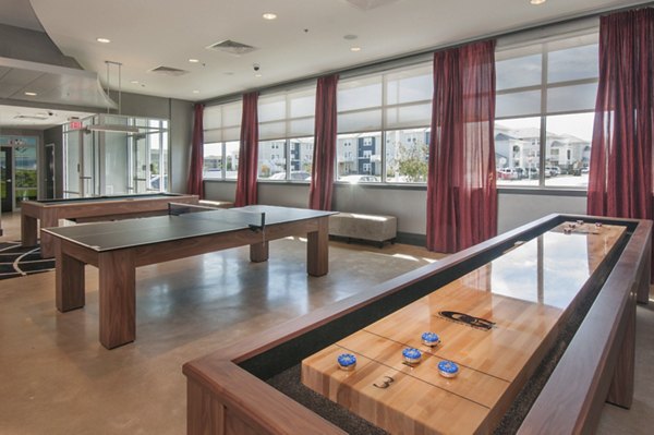 Game room featuring billiards and seating at The Ave at Norman Apartments
