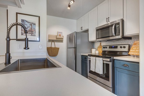 Modern kitchen with stainless steel appliances at Copperwood Apartments, luxury living at Greystar properties