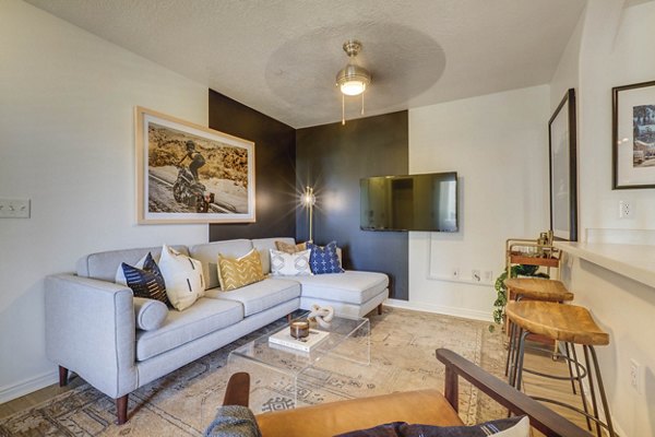 Cozy living room with modern decor and ample natural light at Copperwood Apartments