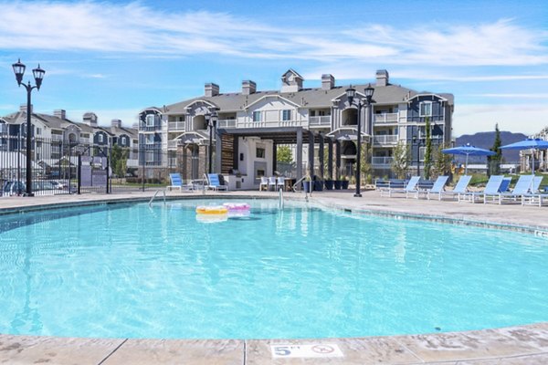 Resort-style pool with lounge chairs at Bay Court at Harbour Pointe Apartments, offering relaxation and views in a luxury apartment community