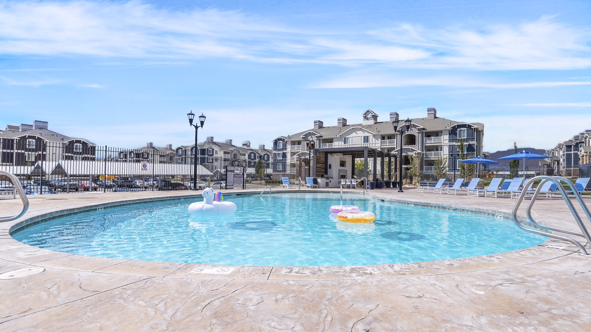 Resort-style pool with loungers at Bay Court at Harbour Pointe Apartments