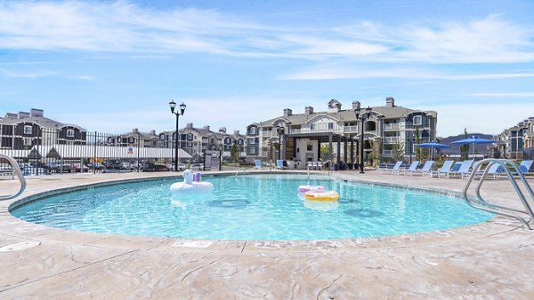 Resort-style pool with loungers at Bay Court at Harbour Pointe Apartments