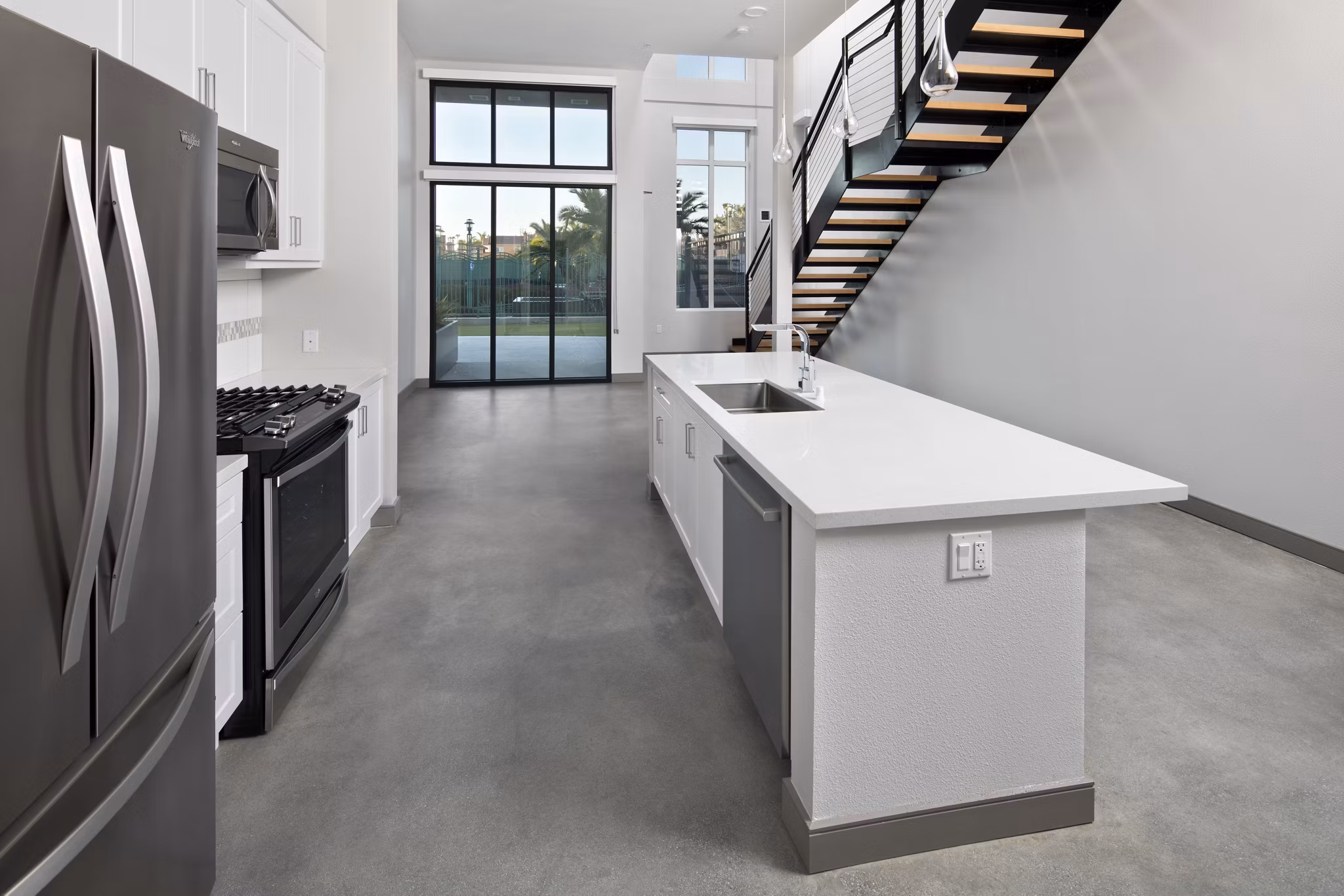 Modern kitchen with stainless steel appliances at Pierside Apartments