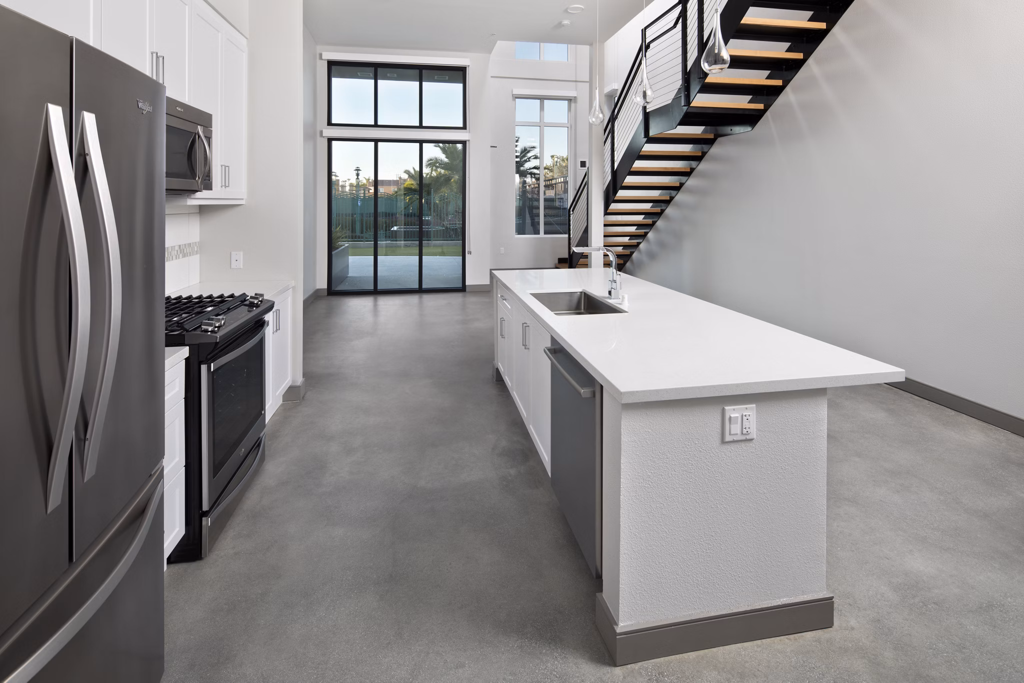 Modern kitchen with stainless steel appliances at Pierside Apartments