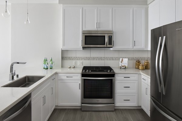 Modern kitchen with stainless steel appliances at Pierside Apartments