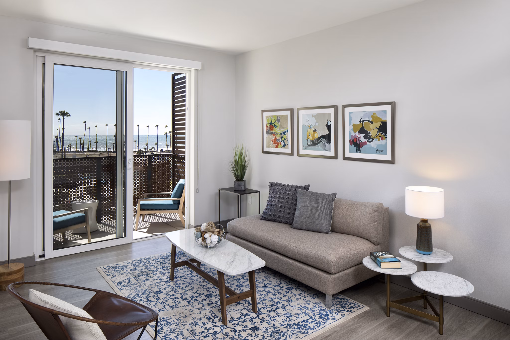 Modern living room with coastal-themed decor in Pierside Apartments, offering luxury waterfront living