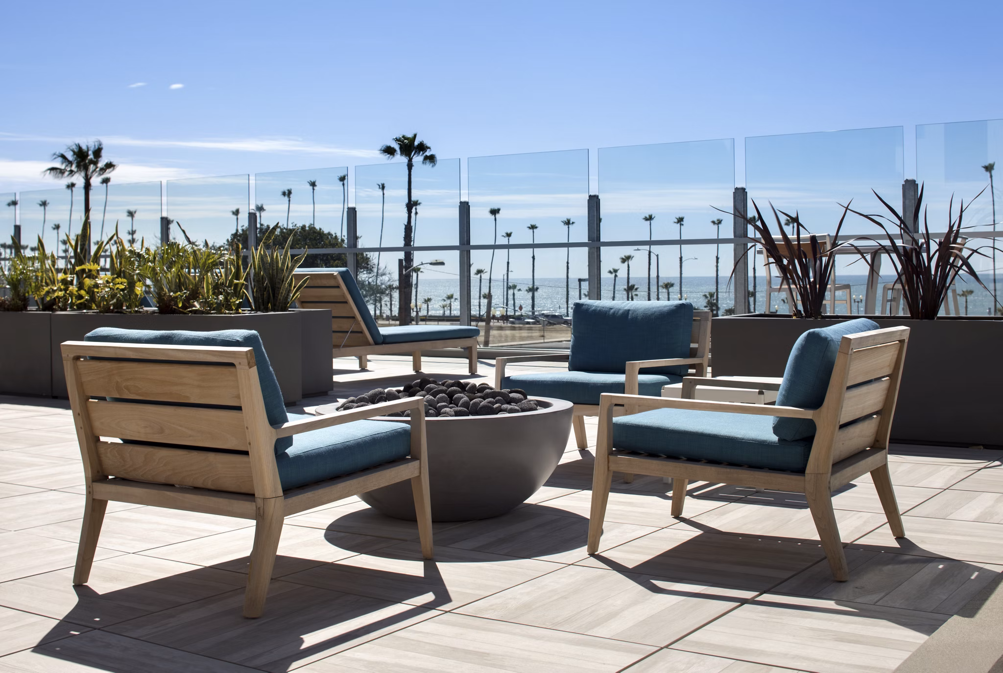 Cozy firepit surrounded by seating at Pierside Apartments, a luxury living community offering waterfront views