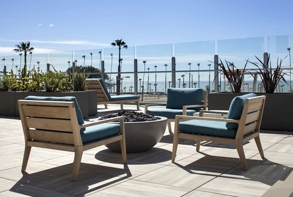 Cozy firepit surrounded by seating at Pierside Apartments, a luxury living community offering waterfront views
