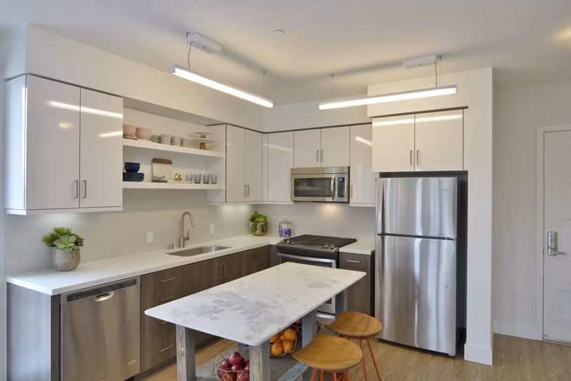 Modern kitchen featuring stainless steel appliances and granite countertops in Parker luxury apartments