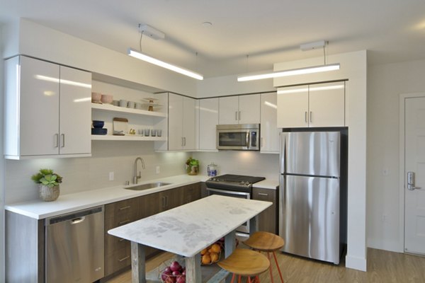 Modern kitchen featuring stainless steel appliances and granite countertops in Parker luxury apartments