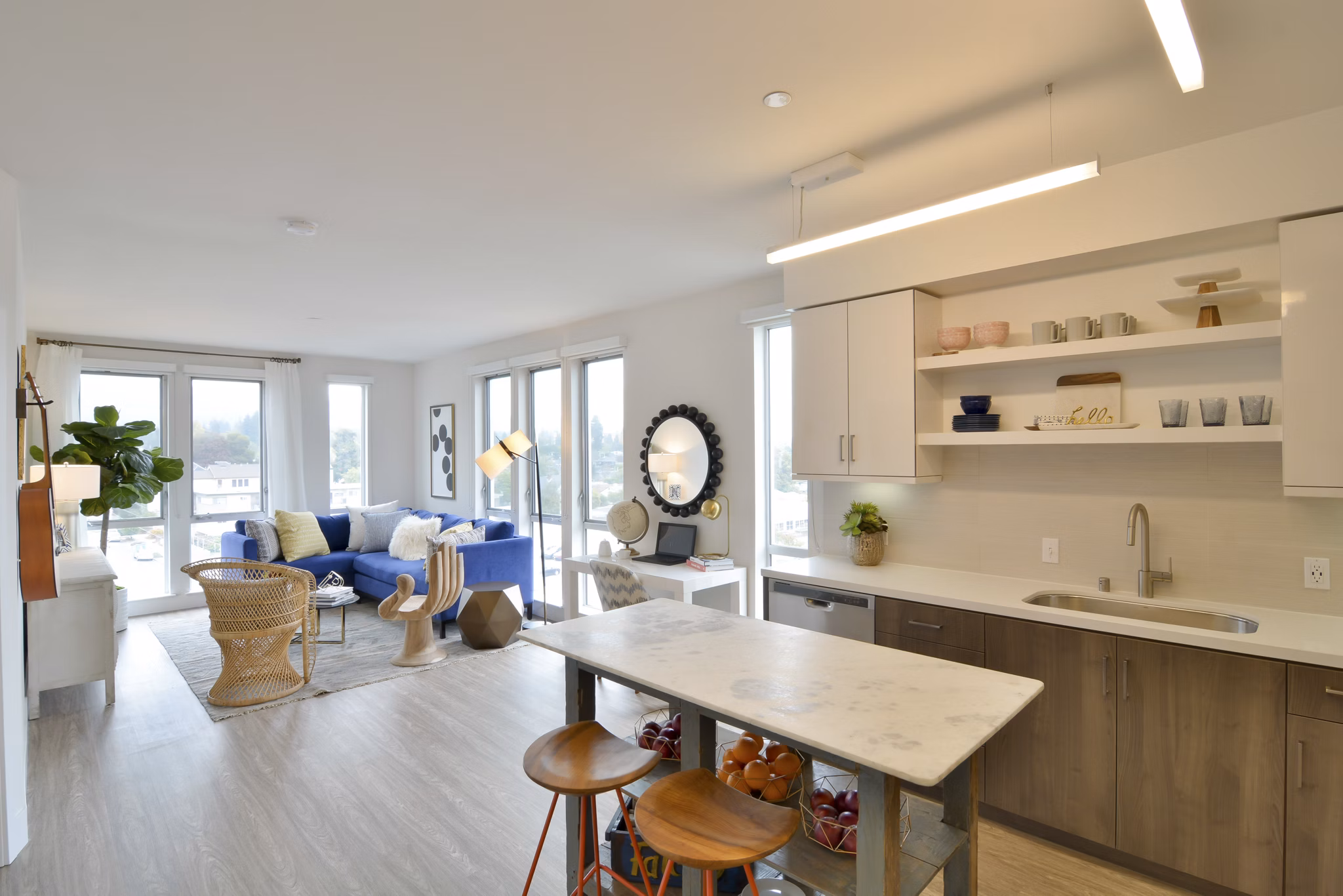 Spacious living room with modern decor and large windows at Parker luxury apartments
