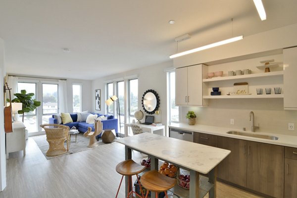 Spacious living room with modern decor and large windows at Parker luxury apartments