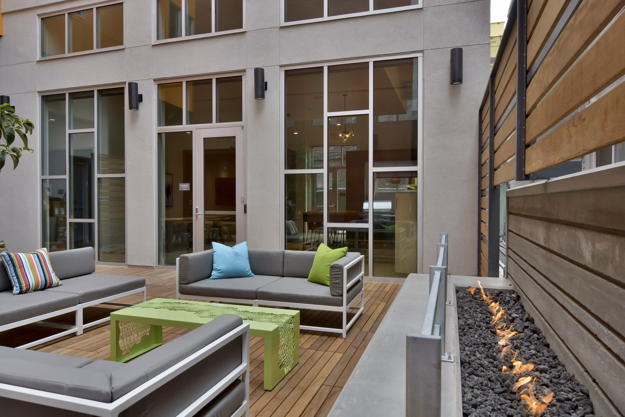 Stylish patio area at Parker Apartments with modern outdoor furniture and lush greenery, ideal for relaxation and social gatherings