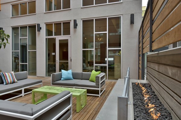 Stylish patio area at Parker Apartments with modern outdoor furniture and lush greenery, ideal for relaxation and social gatherings