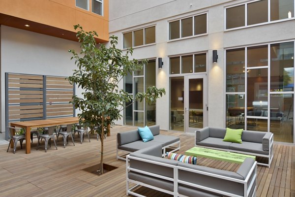 Parker Apartments: Cozy patio area with outdoor seating and lush greenery, perfect for relaxation and social gatherings