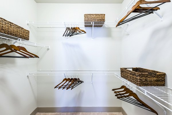 Empty walk-in closet with wire shelves and wicker baskets at Platform Apartments